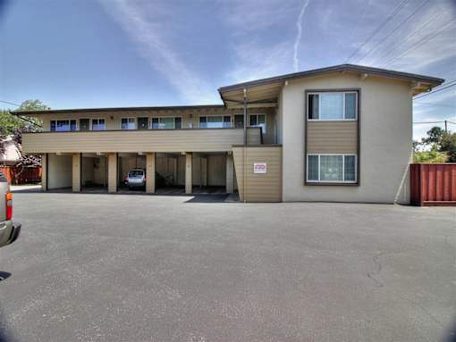 A building with a parking lot in front of it.