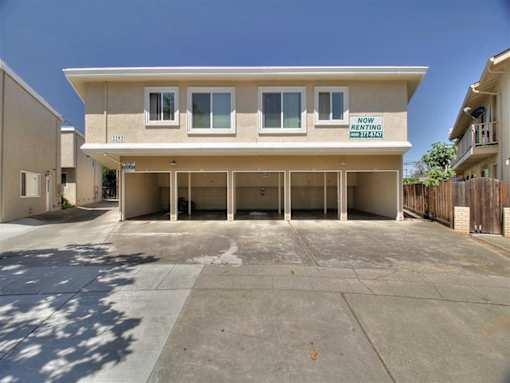 A two-story building with a sign that says