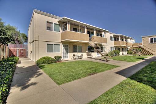 Apartment complex with a green lawn in front.