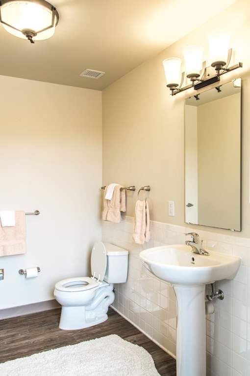 A white toilet and sink in a bathroom.