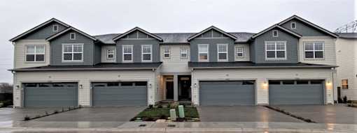 Large house with a grey garage door.