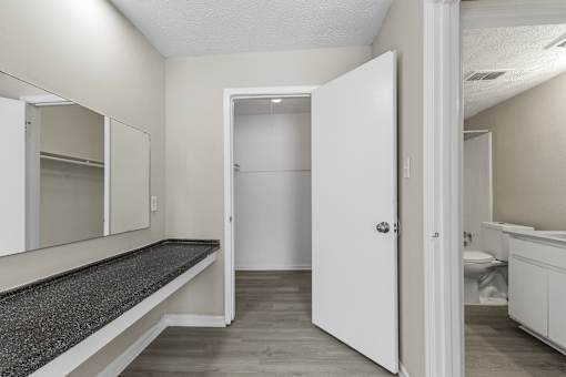 A white door is open to a bathroom.