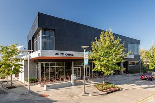 A modern building with a glass facade and a sign that reads