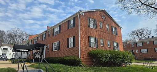 A brick building with a black awning in front.