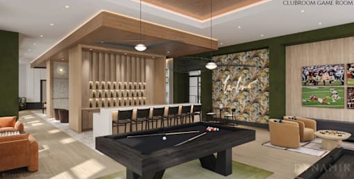 A pool table is in the middle of a room with a green wall and a sign that says "Clubroom Game Room".