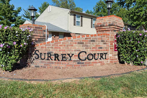 A brick wall with Surrey Court written on it.