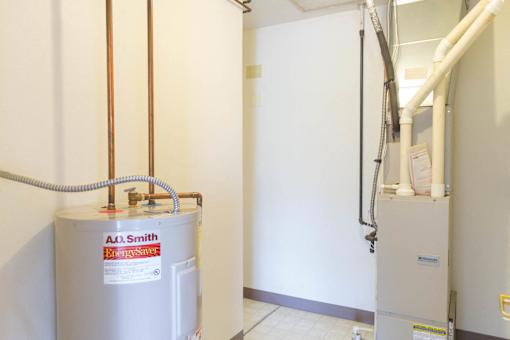 A.L. Smith water heater in a room.