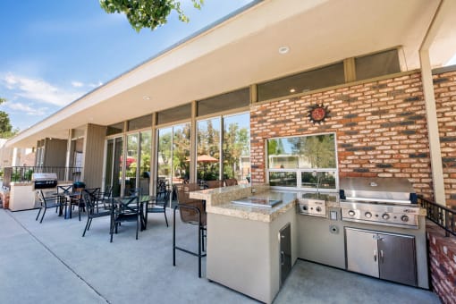 The Biltmore BBQ and outdoor seating area is close to the main pool and outside of the leasing office. It has two BBQ's with tables and chairs.