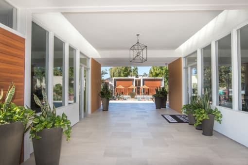 The Biltmore breezeway entrance to the property has a view of the main swimming pool with cabanas. To the right of the breezeway is the leasing office.