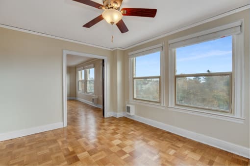 Living Room with Spacious Area, Overzied Windows, Wood-Style Flooring, and Ceiling Fan at Malloy Apartment Homes, Seattle, 98105
