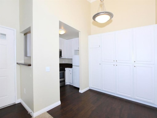 Kitchen and dining room view with white cabinetry