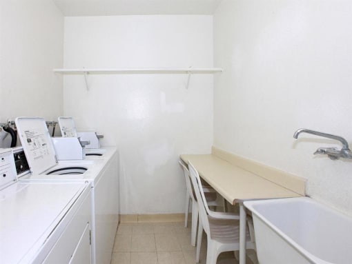 Laundry room with folding table and washing machines