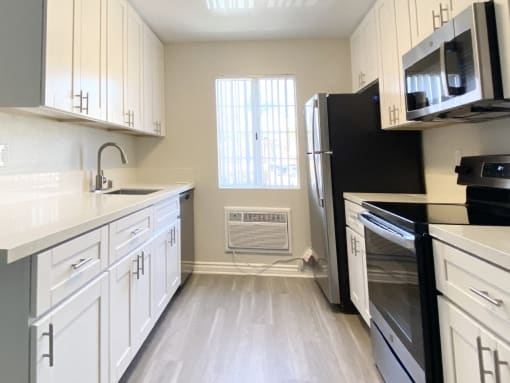 kitchen with stove, sink and fridge