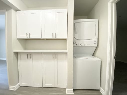 Laundry in unit with cabinets