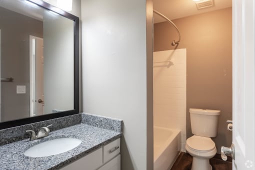 Bathroom wth granite counters and large vanity