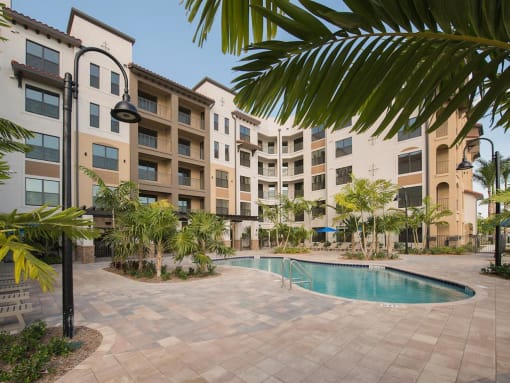The Crystal Riviyera's backyard, featuring a pool, sun deck, barbecue area, and a view of Sailboat Lake.