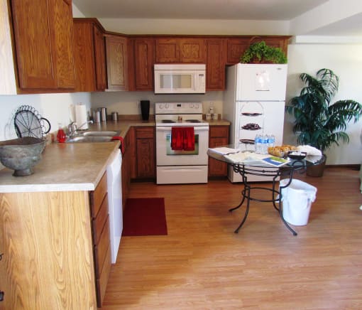 A kitchen with wooden cabinets and a white fridge.
