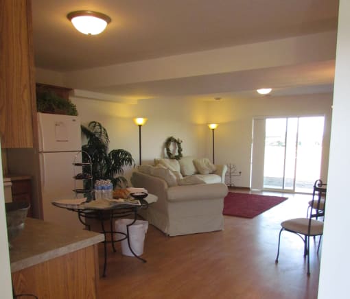 A living room with a couch, chair, and table.
