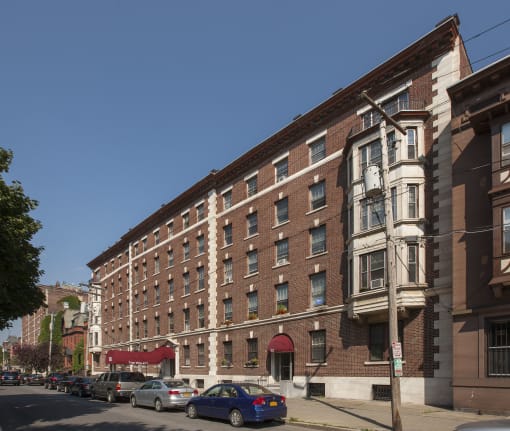 Building with balconies and a sidewalk at Willett Apartments, Albany, NY