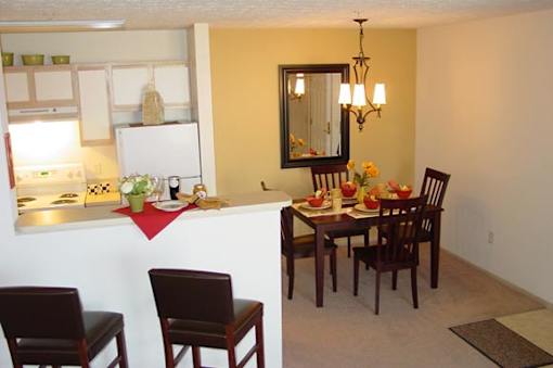 A kitchen with a table set for a meal.