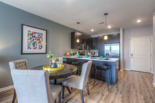 a kitchen and dining area with grey walls  at EdgeWater at City Center, Lenexa, Kansas