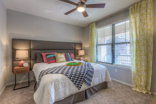 Bedroom with large bed and ceiling fan  at EdgeWater at City Center, Kansas, 66219
