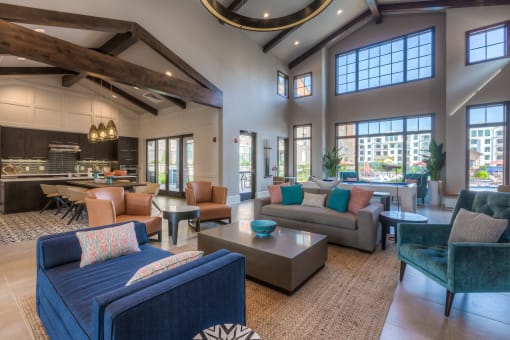 a spacious living room with a vaulted ceiling and large windows  at EdgeWater at City Center, Kansas