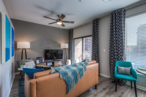 a living room with gray walls and a ceiling fan  at EdgeWater at City Center, Lenexa, KS, 66219