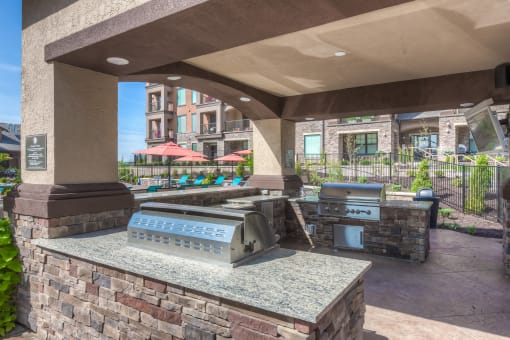 an outdoor grill area with two bbq grills  at EdgeWater at City Center, Lenexa, 66219