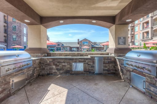 an outdoor kitchen with two stoves and a large window  at EdgeWater at City Center, Lenexa, Kansas