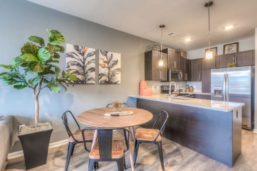 an open kitchen and dining room with a table and chairs  at Waterside Residences on Quivira, Lenexa