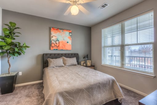 a bedroom with a bed and a ceiling fan  at Waterside Residences on Quivira, Lenexa, KS, 66215