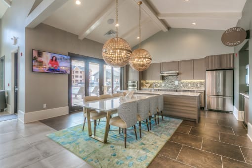community kitchen with a large island and a table with chairs  at Waterside Residences on Quivira, Lenexa, KS