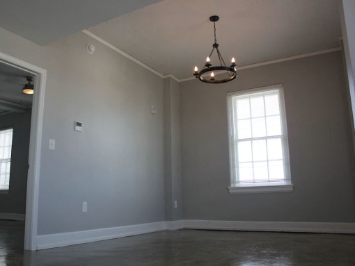 Soft grey walls and hanging chandelier in Thomas Jefferson Tower Apartment at Thomas Jefferson Tower, Birmingham, AL, 35203