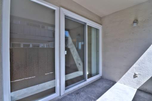 A white sliding door with a glass window is open.
