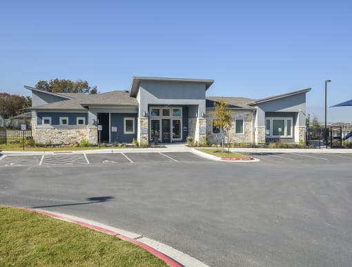 Stylish community building with contemporary architecture, landscaped frontage, and a clear front entryway.