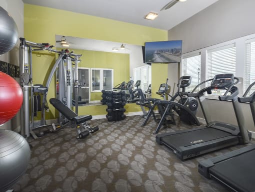 Resident fitness center featuring cardio equipment, strength-training stations, and dedicated space for a variety of workout routines.