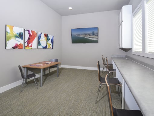Dedicated resident business center featuring workstations, collaborative seating, and a comfortable environment for productivity.