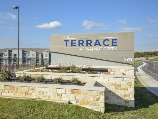 Well-maintained property entrance highlighted by attractive landscaping and modern design elements.