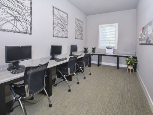 Dedicated business center featuring computer workstations, printing capabilities, and a quiet environment for work or study.