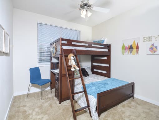 Versatile bedroom with a bunk bed setup, built-in features, and a clean, well-lit design.