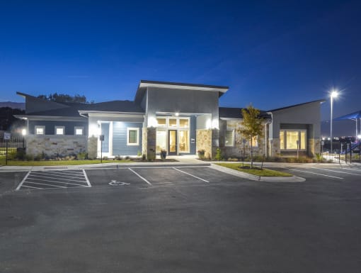 Contemporary leasing office exterior illuminated in the evening with a welcoming entryway and modern finishes., Austin, TX 78724