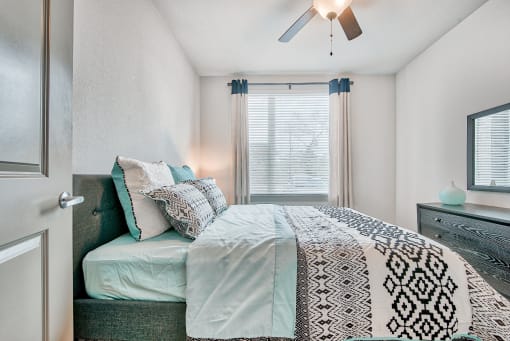 Encore at Westfork Bedroom with beautiful natural lighting coming in through the window.