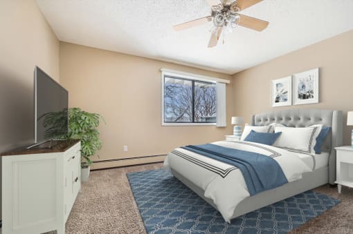 a bedroom with a large bed and a ceiling fan at Heritage Hills Apartments, Bloomington, 55437
