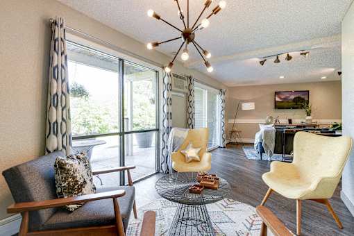 Community Room with a large window and a chandelier at Pheasant Park Apartments, Minnesota