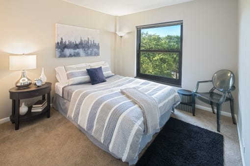 Bedroom with window with a view of the city at Eden Commons, Chicago, Illinois