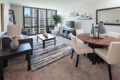 Living room layout with floor to ceiling windows, seating, and interior furnishings at Eden Commons, Illinois