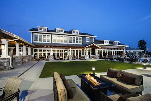 Outdoor seating area with patio couches and fire pits at The Lakes of Valparaiso