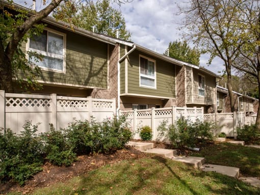 Townhome style units with decorative fence and steps at The Brook At Columbia Apartments, Maryland