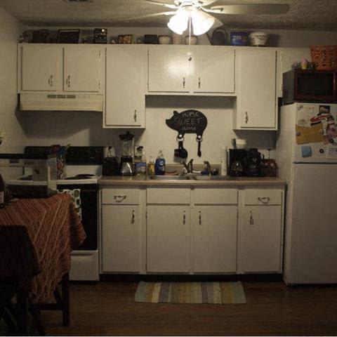 a kitchen with a sink refrigerator stove and microwave